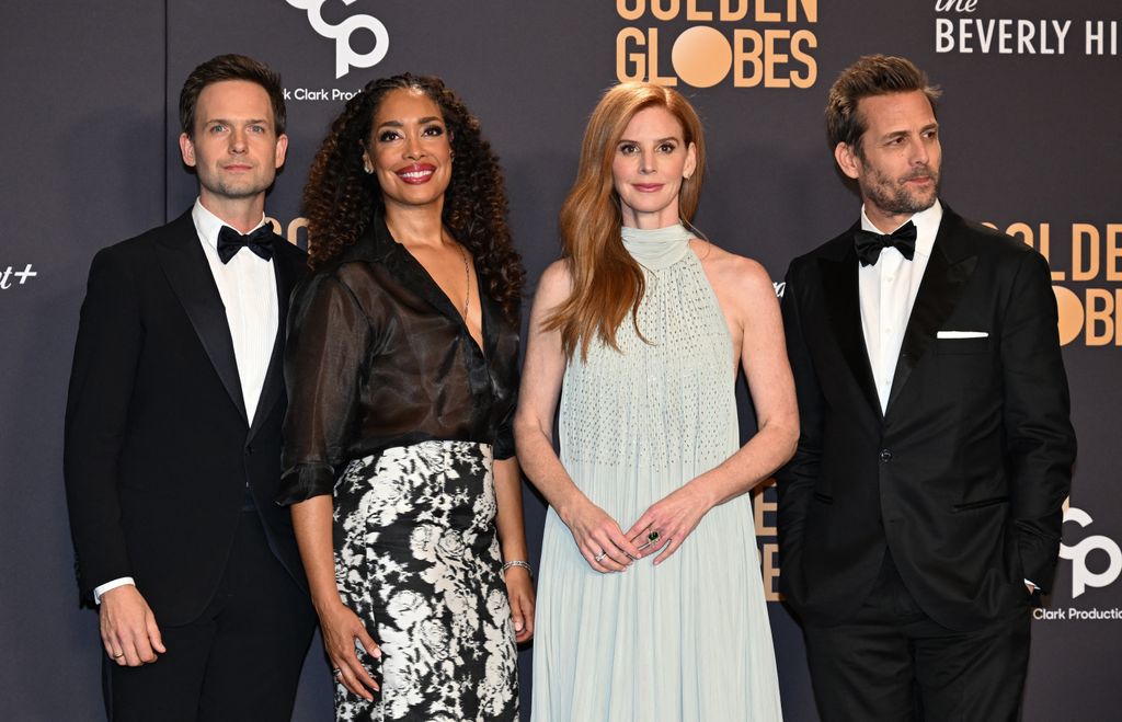 Actors Patrick J. Adams, Gina Torres, Sarah Rafferty and Gabriel Macht pose in the press room during the 81st annual Golden Globe Awards 