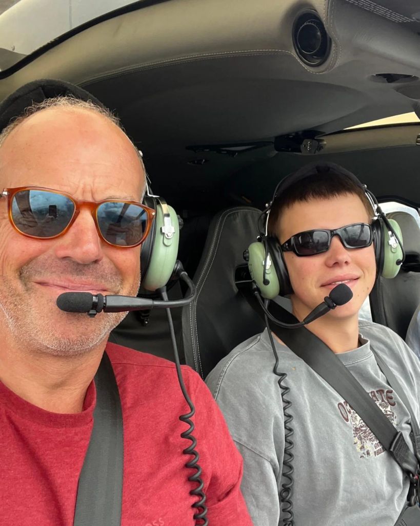 phil spencer in helicopter with son 