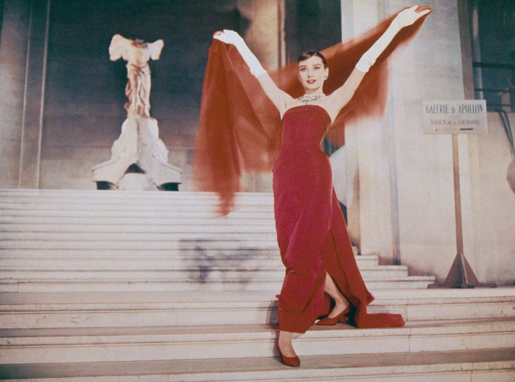 Audrey Hepburn descends the Daru Staircase at the Louvre in Paris.