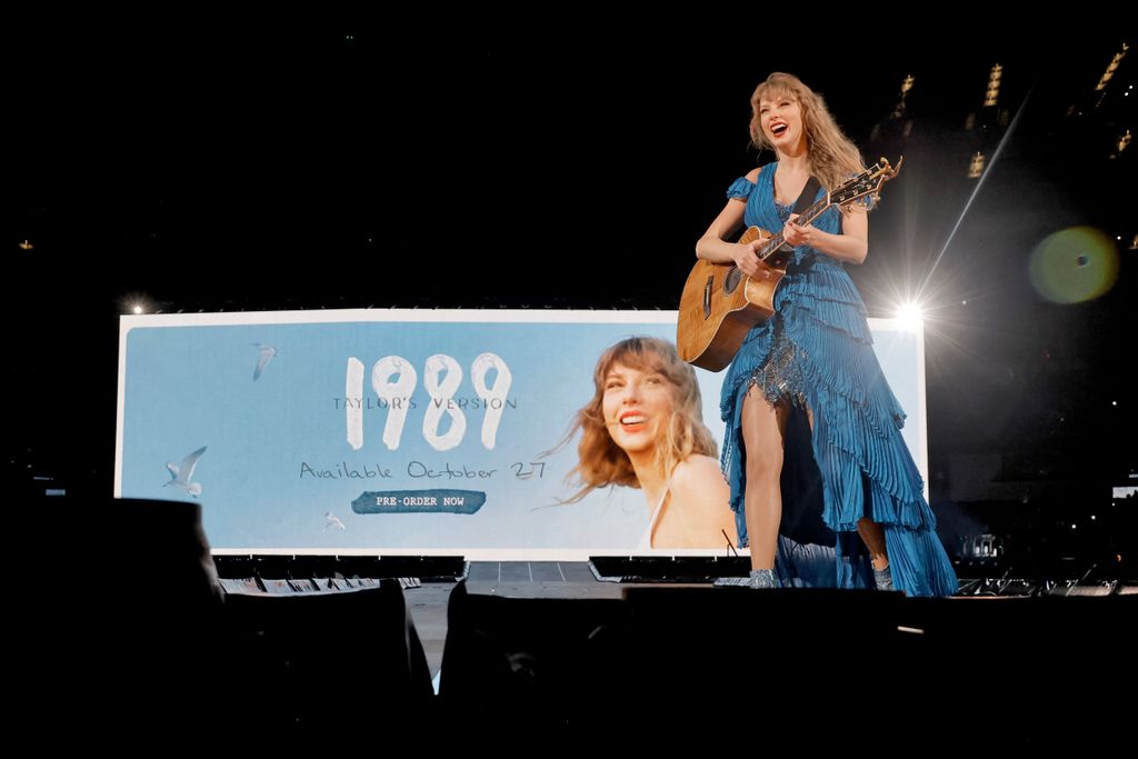 Taylor Swift stands on stage and reveals 1989 wil be the next re-record release 