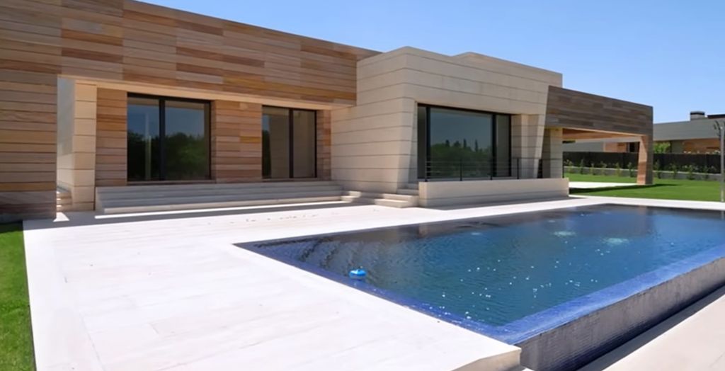 An exterior shot of a house with a pool