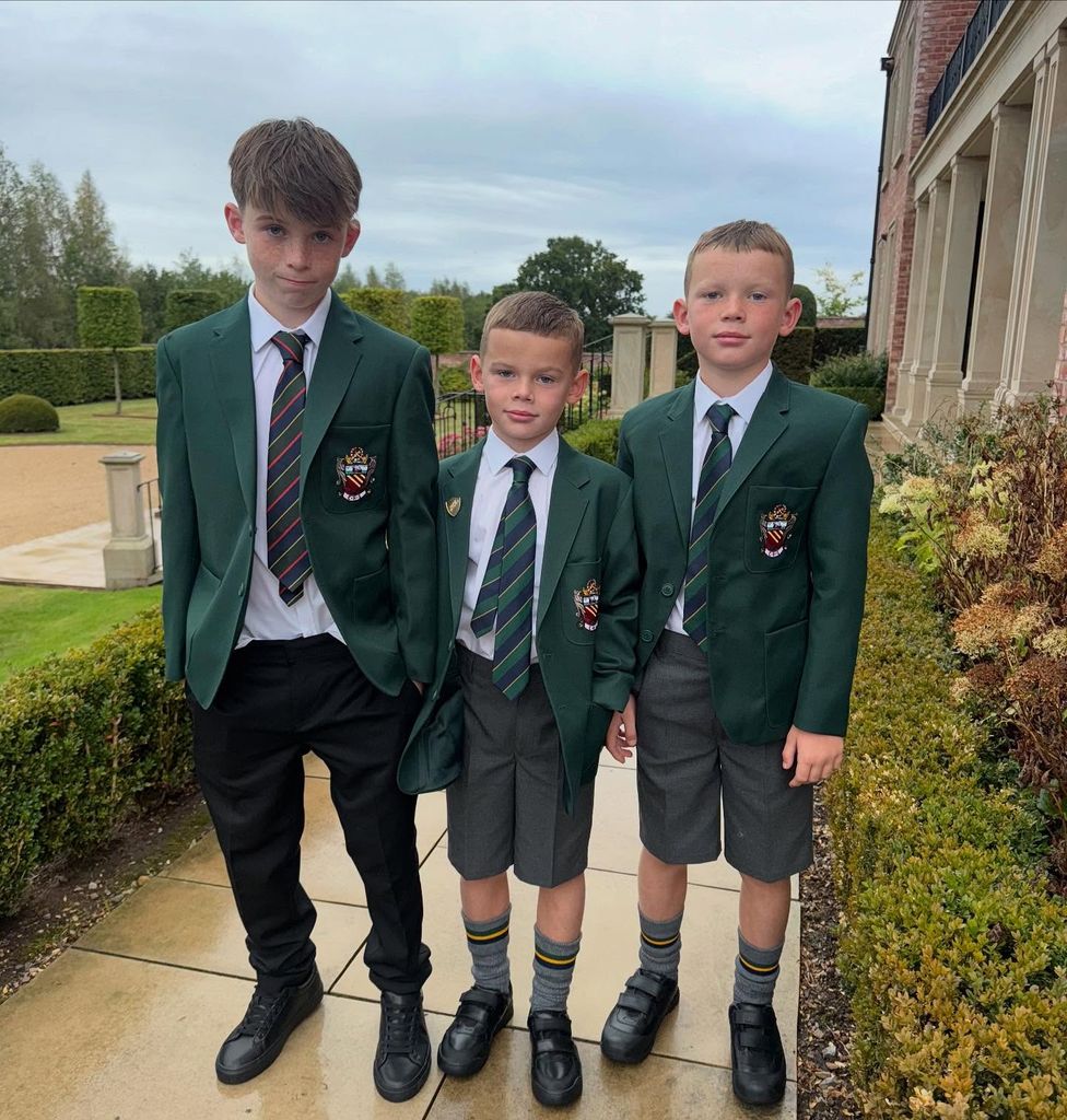 three boys in green school uniform