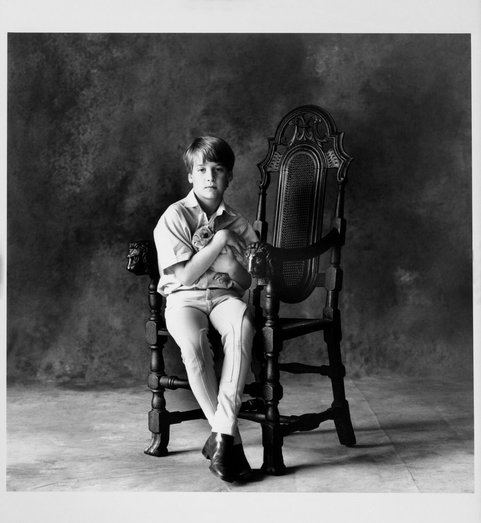 Prince William photographed by Lord Snowdon in 1991, holding his pet rabbit on a chair