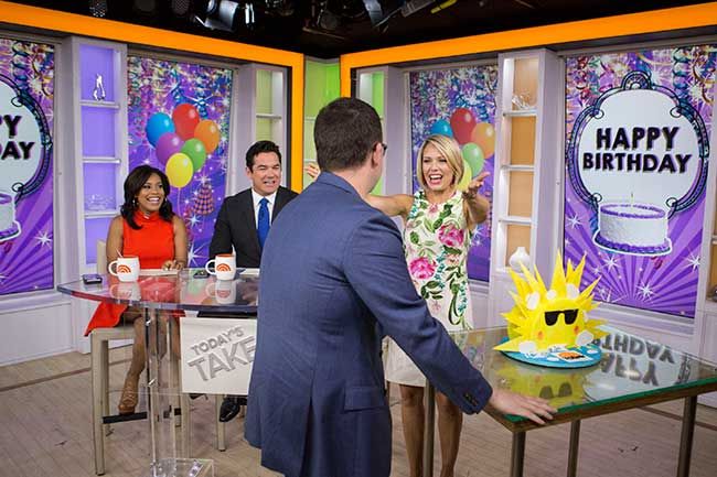 Brian wheeling in a birthday cake for Dylan as she hosts the Today Show