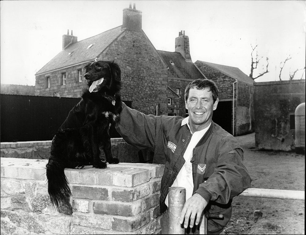 John Nettles posing by the home he used to rent in Jersey