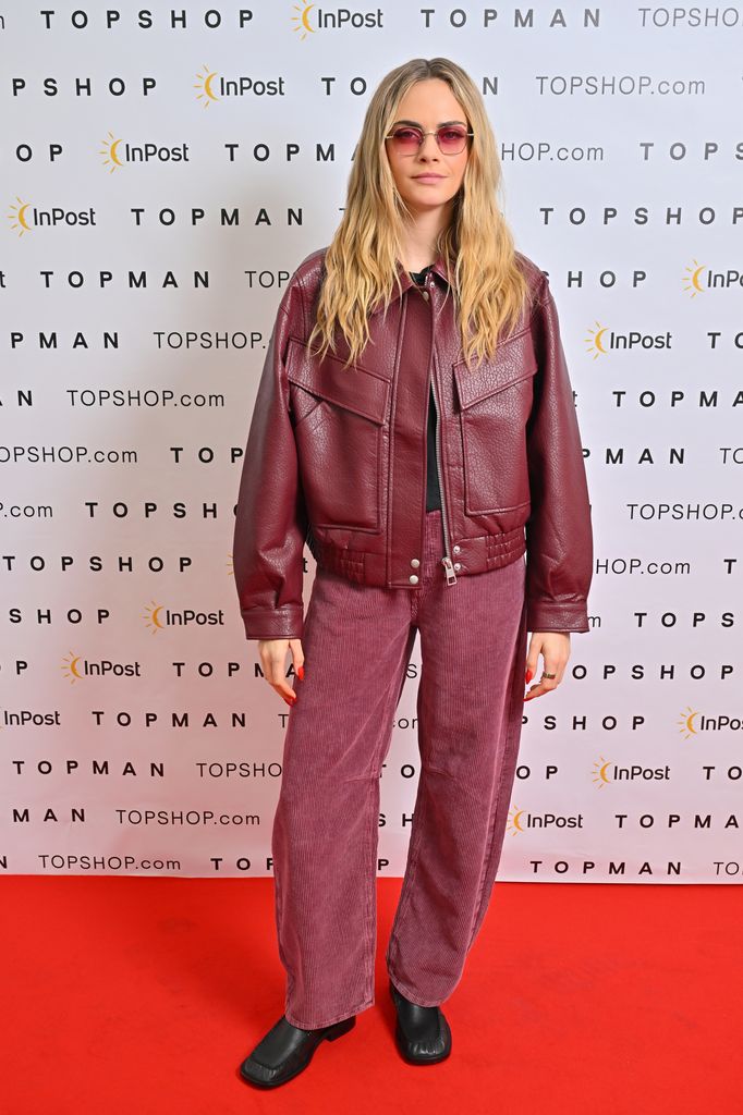  Cara Delevingne posed in burgundy trousers and jacket