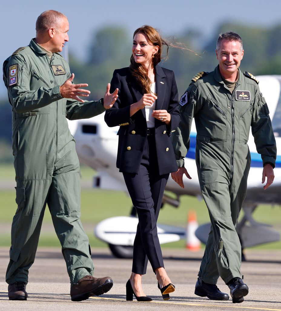 Kate Middleton walking with two servicemen