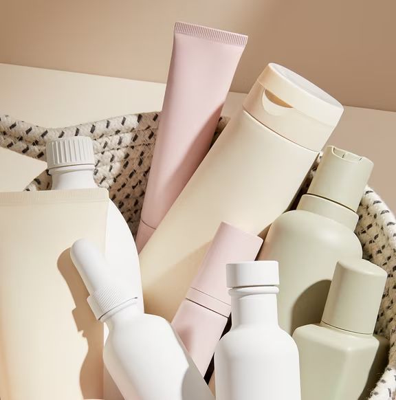 plain makeup and beauty bottles in a basket