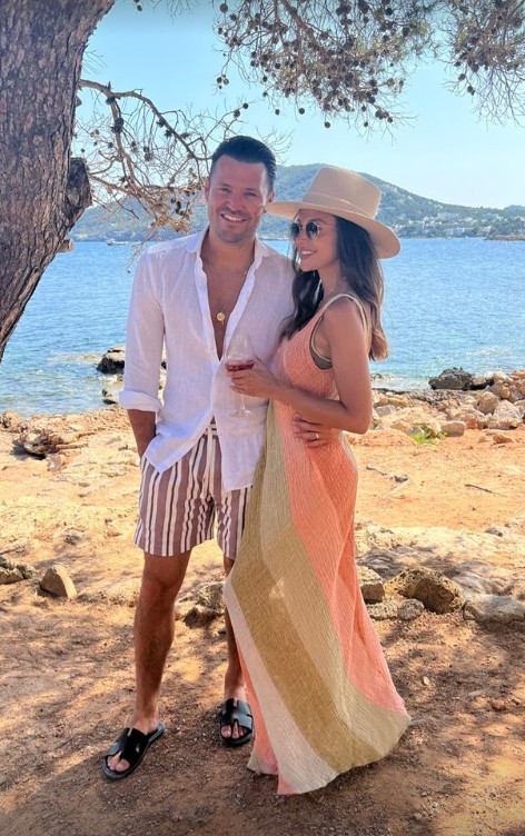 Mark Wright and Michelle pose together in front of sea in Ibiza