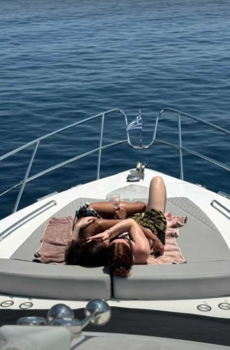 Alex Scott and Jess Glynne embracing on a boat