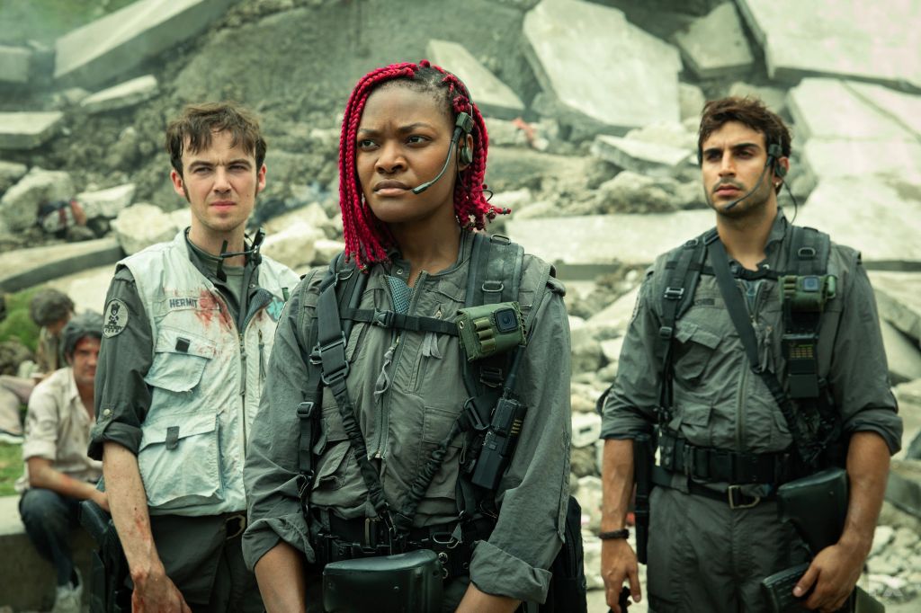 group of soldier standing in front of wall of rocks