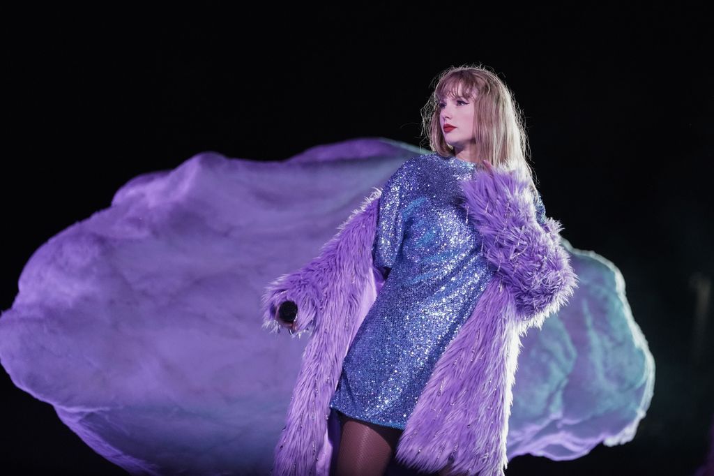 Taylor Swift on stage in purple