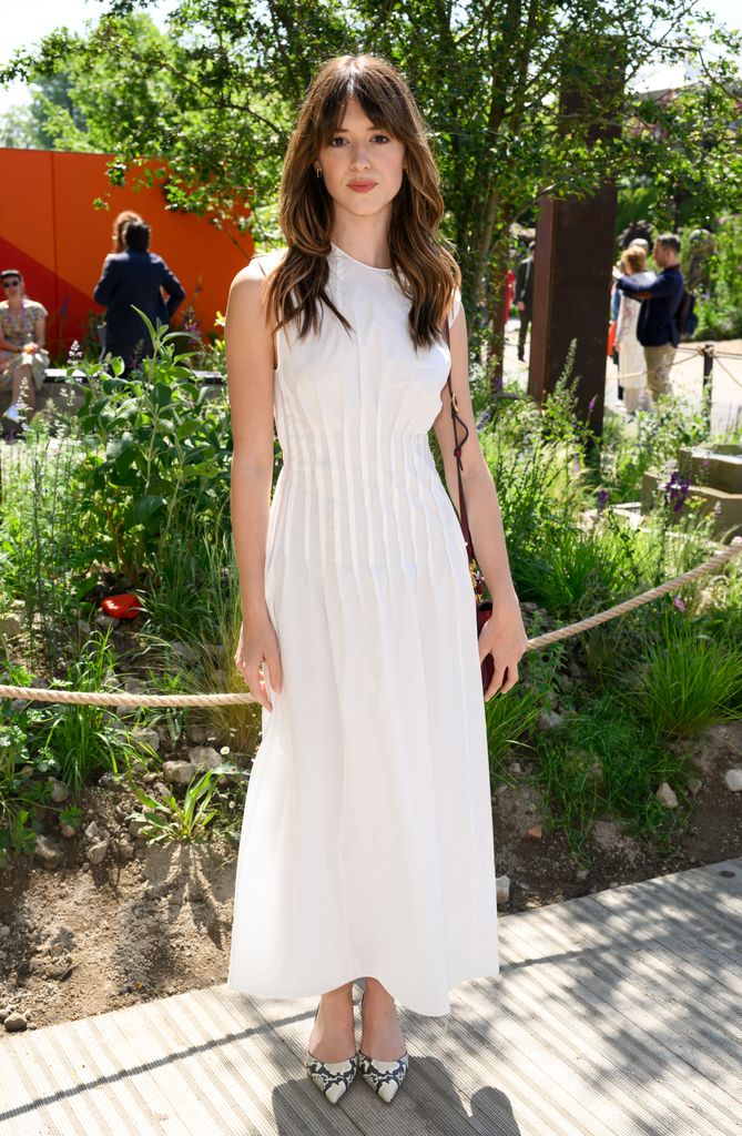 Daisy Edgar-Jones attends The RHS Chelsea Flower Show at Royal Hospital Chelsea in a white dress and heels look