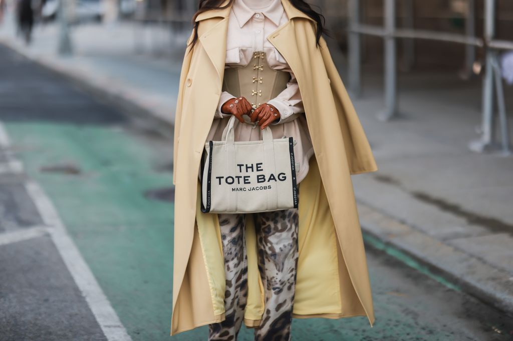 A New York Fashion Week guest with her trendy tote