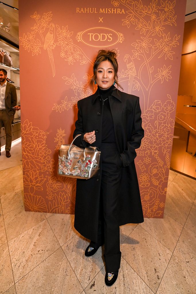 Ashley oozed elegance in an all-black ensemble with a bedazzled gold bag and loafers from the collection