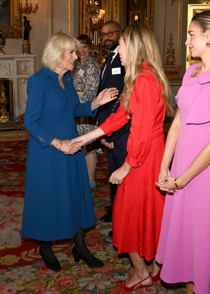 Queen Camilla shakes hands with Carrie Johnson 