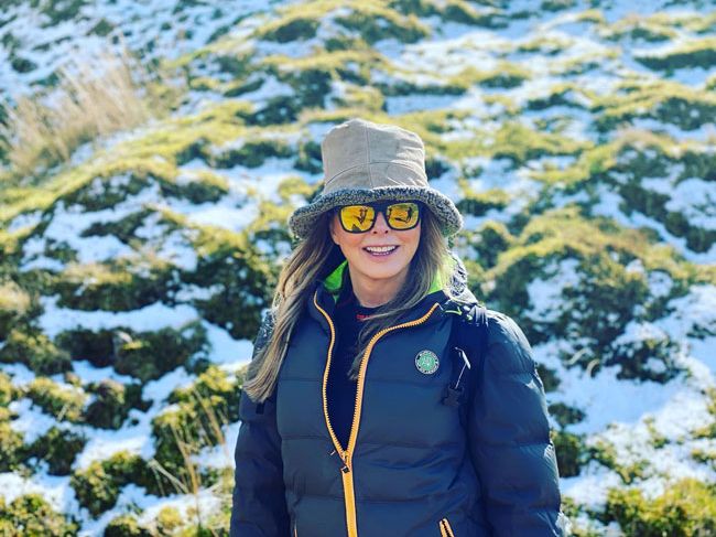 Carol Vorderman out in nature in a cosy hat