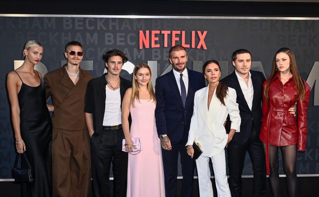 Mia Regan standing with Romeo Beckham, Cruz Beckhan, Harper Beckham, David Beckham, Victoria Beckham, Brooklyn Beckham and Nicola Peltz-Beckham