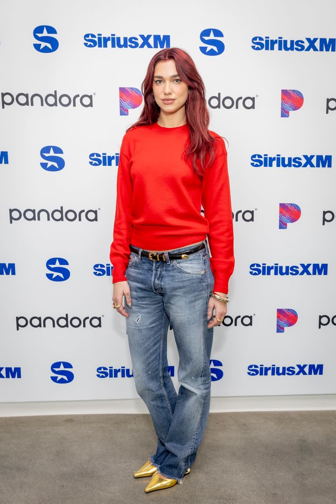 Dua lipa in red sweatshirt and jeans