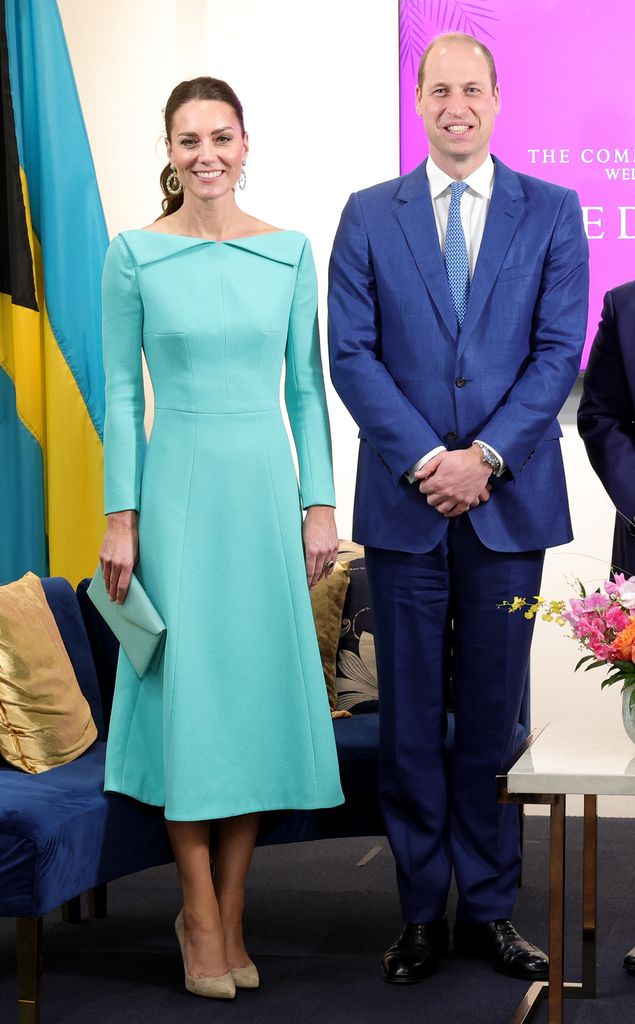 Catherine in blue dress and william pose for photo