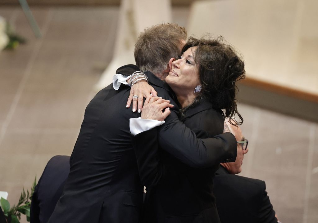 David Beckham and Nancy Dell'Olio hug before  Sven-Goran Eriksson's funeral