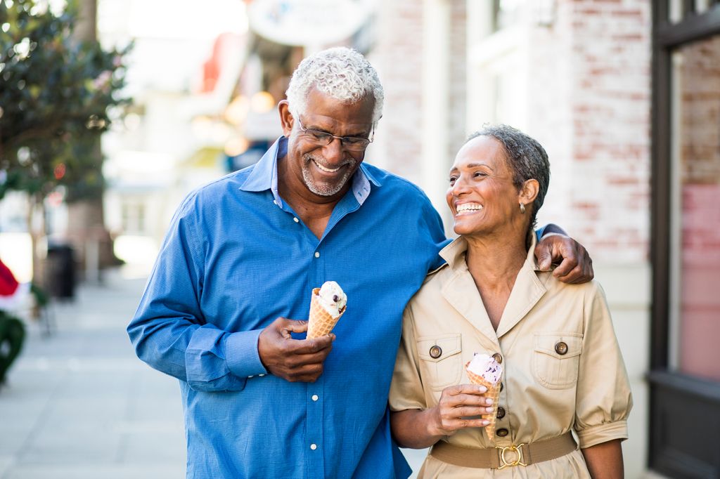 A senior african american couple enjoy an evening on the town with ice cream