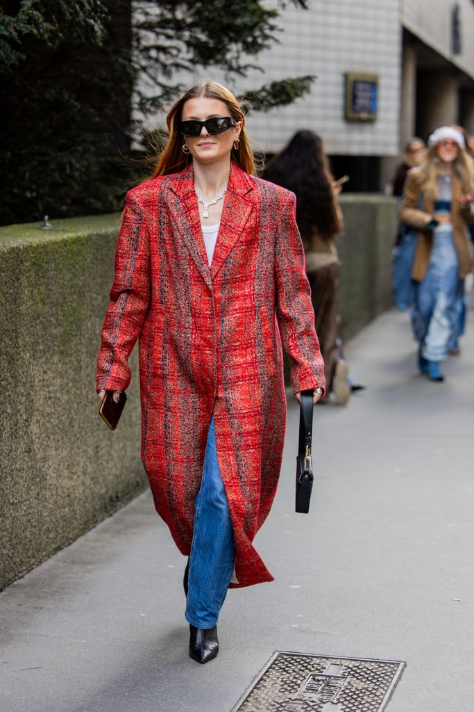 The guest stunned in a red oversized coat, and dressed down diamonds outside the Edward Crutchley show.