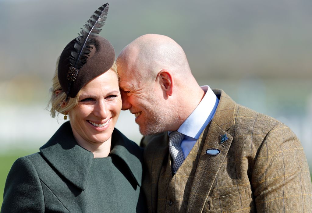 Zara Tindall smiling with Mike Tindall with his face rested on hers 