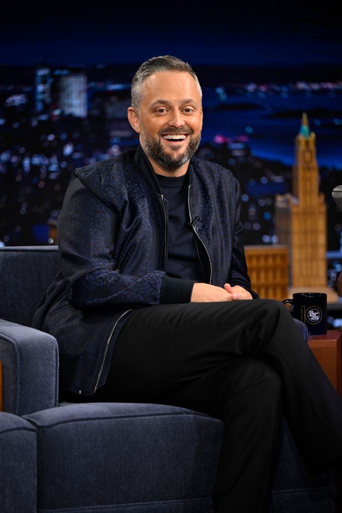 Nate in black pants and navy jacket during interview on Jimmy Fallon