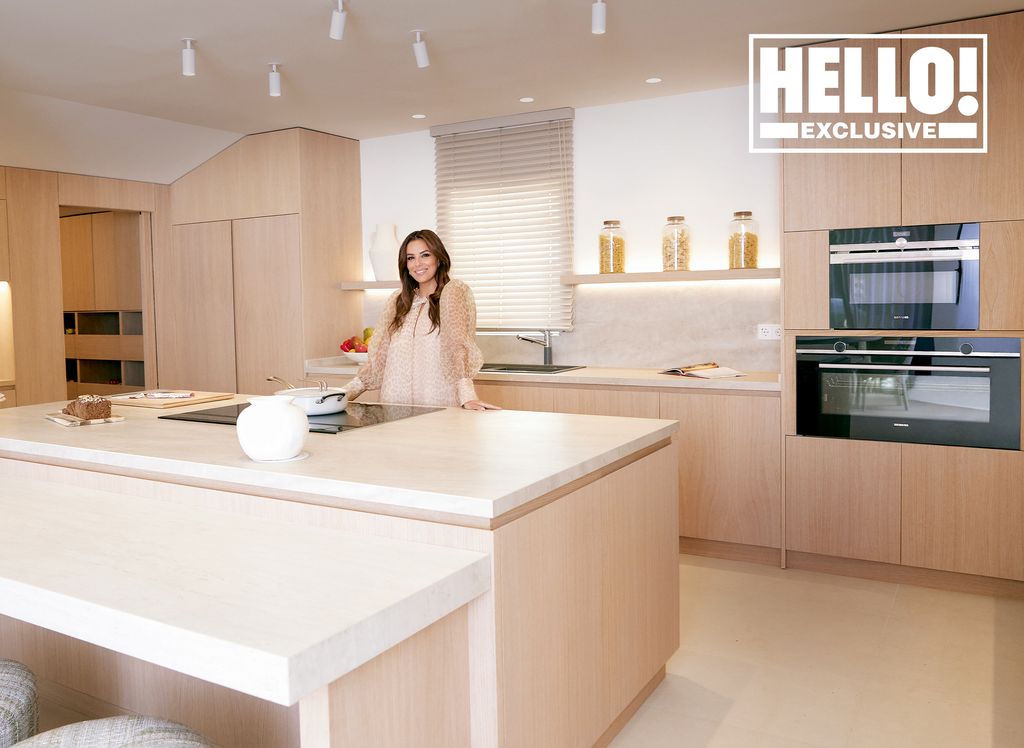 Eva Longoria posing in modern Marbella home kitchen 
