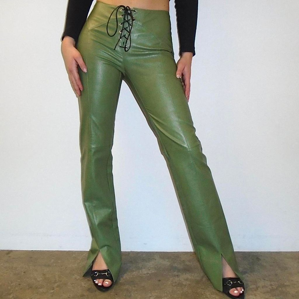 Woman wears green vegan leather lace-up trousers