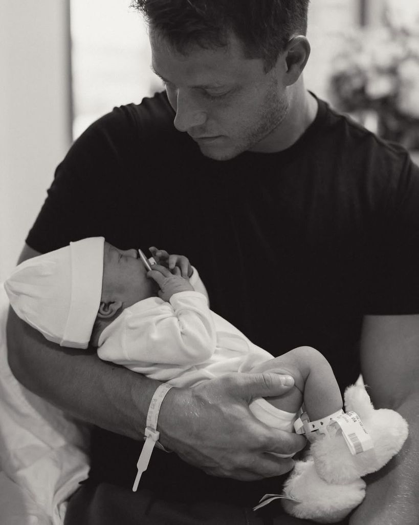 Christian McCaffrey holds his newborn baby girl, shared on Instagram