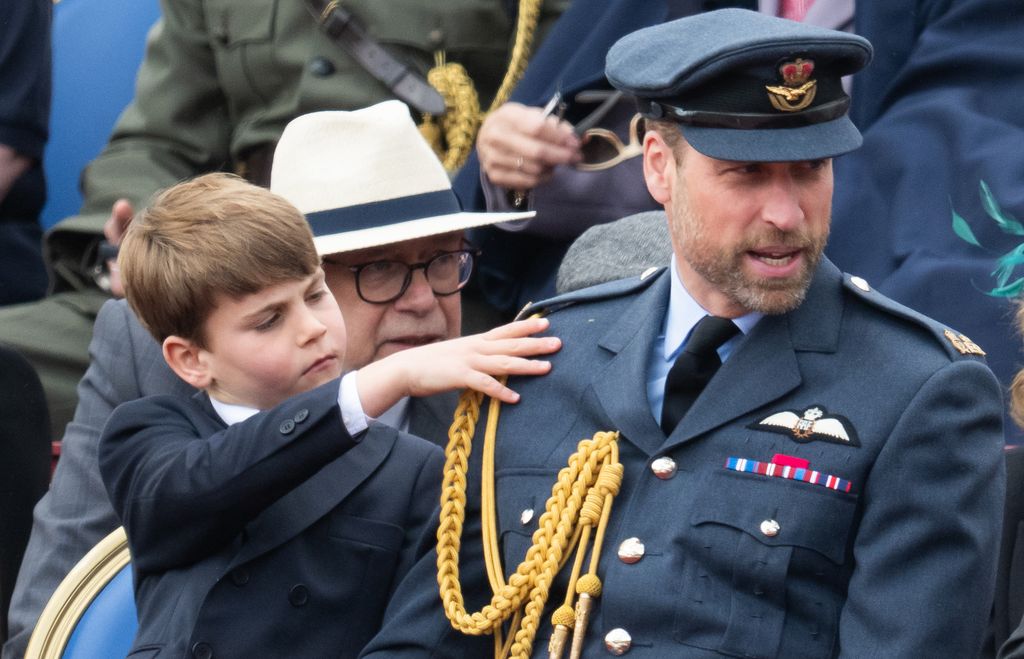 Prince Louis trying to get Prince William's attention during the military procession to mark the 80th anniversary of VE Day on May 05, 2025 in London, England.