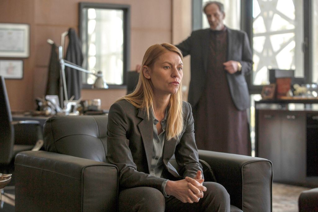 woman in suit sitting on chair in office