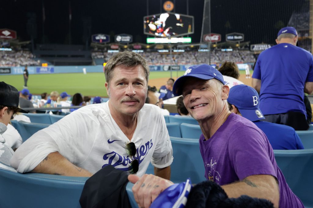 Brad Pitt and Flea pose for a photo during Game Four of the 2025 World Series presented by Capital One between the Toronto Blue Jays and the Los Angeles Dodgers at Dodger Stadium on Tuesday, October 28, 2025 in Los Angeles, California.