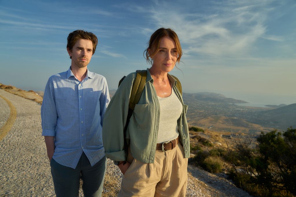 young man and woman standing on deserted road 
