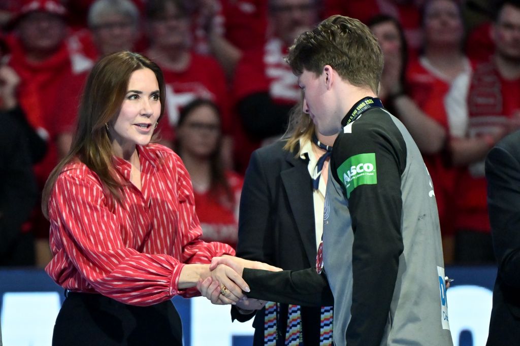 Denmark's Queen Mary comforts Nils Lichtlein of Germany as he receives the silver medal