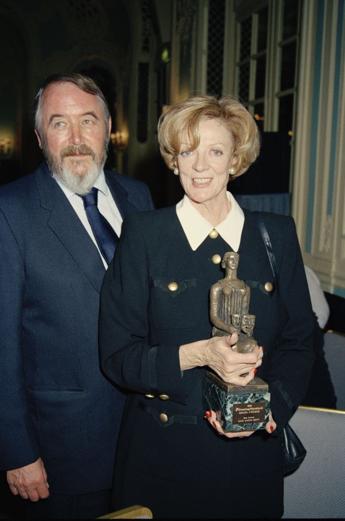 Maggie Smith, winner of the Best Actress award for "Three Tall Women" poses with her husband, playwright Beverley Cross at the Evening Standard Drama Awards in 1994