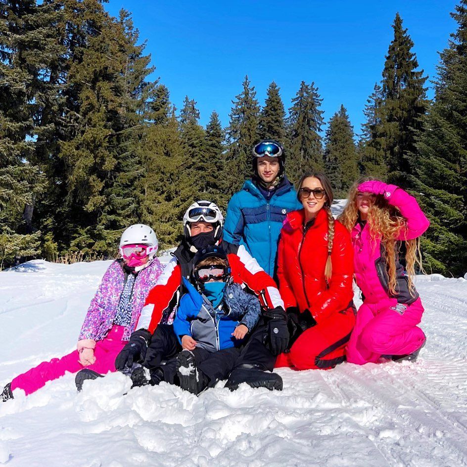 The Andre family posing on a snowy mountain 