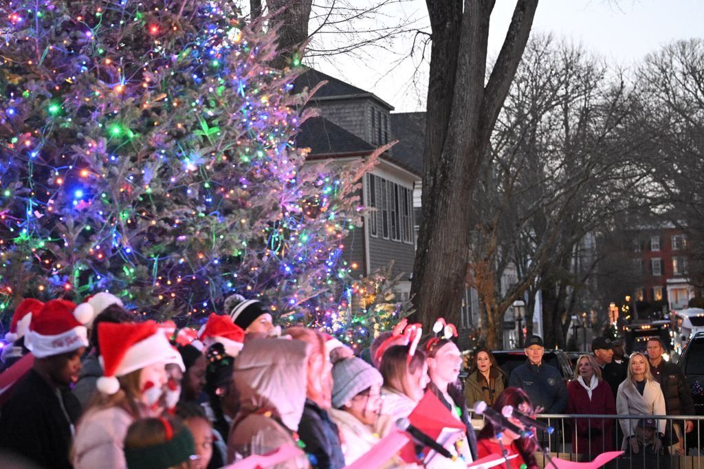 Joe Biden, Ashley Biden, Jill Biden, and Melissa Cohen Biden look on as carolers perform during a Christmas tree lighting in Nantucket, Massachusetts