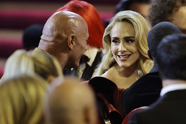 Adele smiles at The Rock during the Grammys