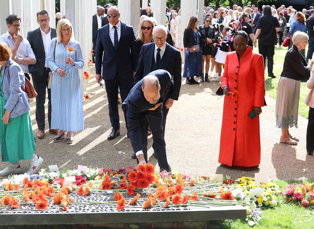 Britain's Prince William, Prince of Wales lays a bouquet of flowers as he attends a service at the 7/7 memorial in London's Hyde Park