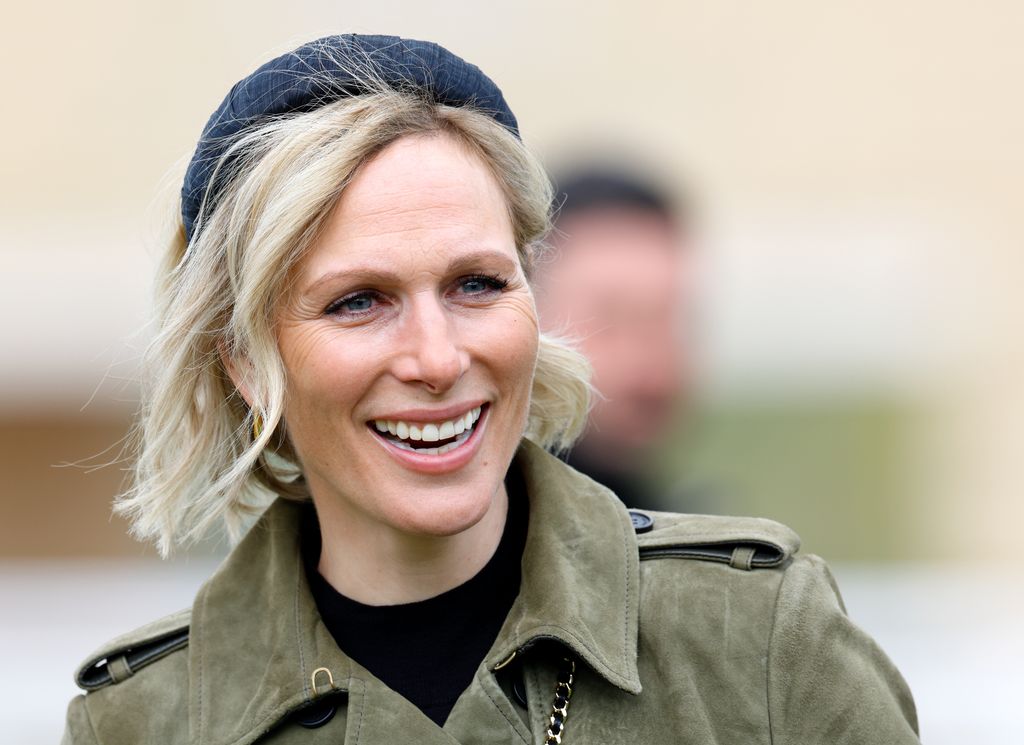 Zara Tindall attends day 2 of the April Meeting at Cheltenham Racecourse 2024 wearing green khaki coat and headband