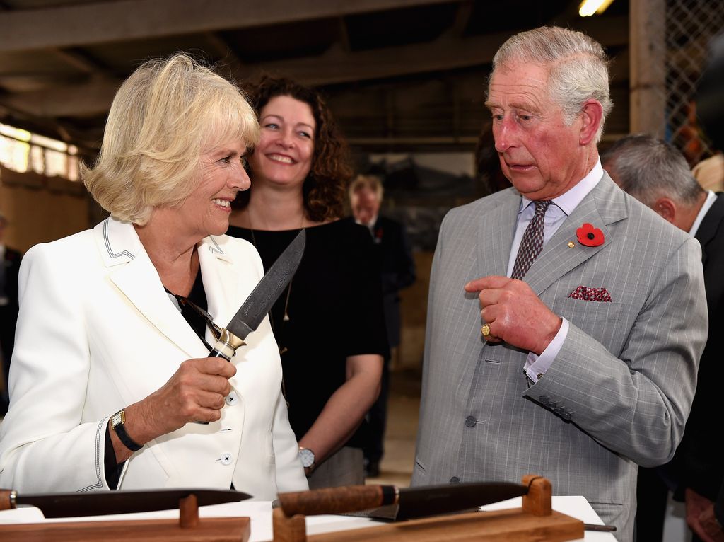 Camilla jokingly wields a knife at Charles at an Australian winery