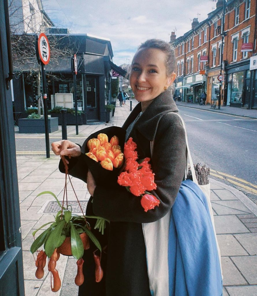 Rose Ayling-Ellis holding bouquet of flowers on London street 