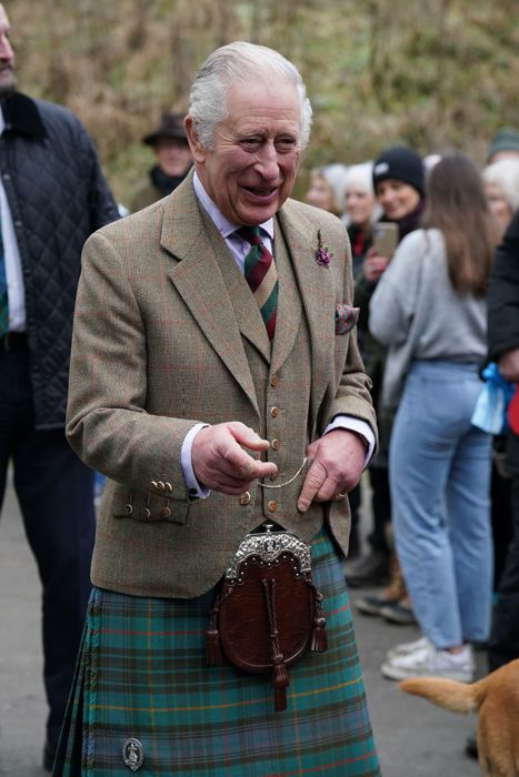 King Charles smiling wearing a kilt