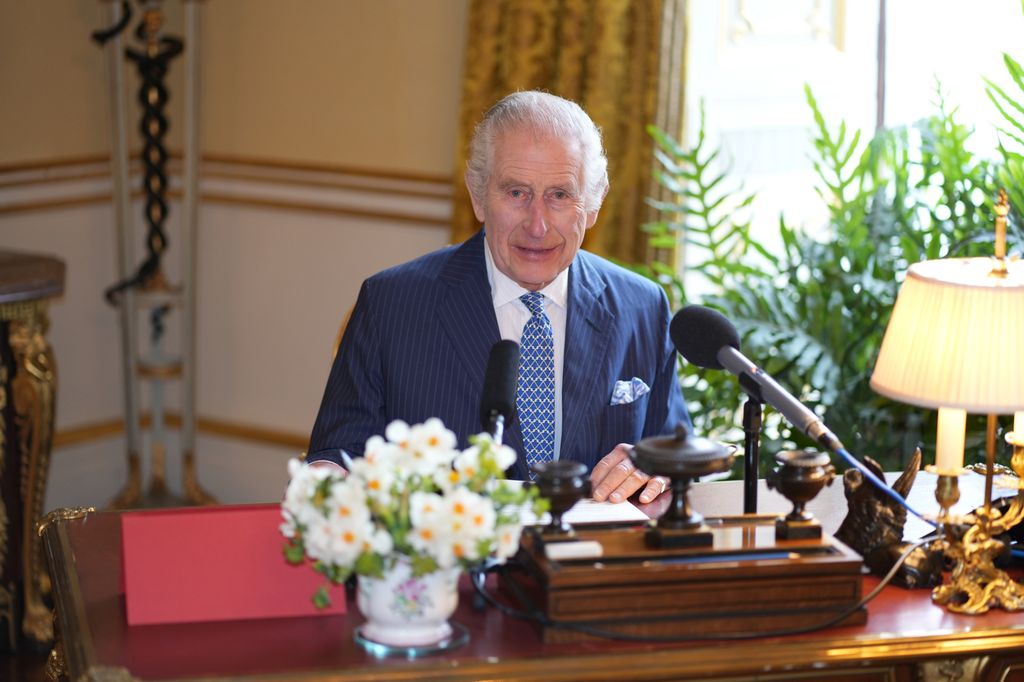 King Charles behind his desk at Buckingham Palace