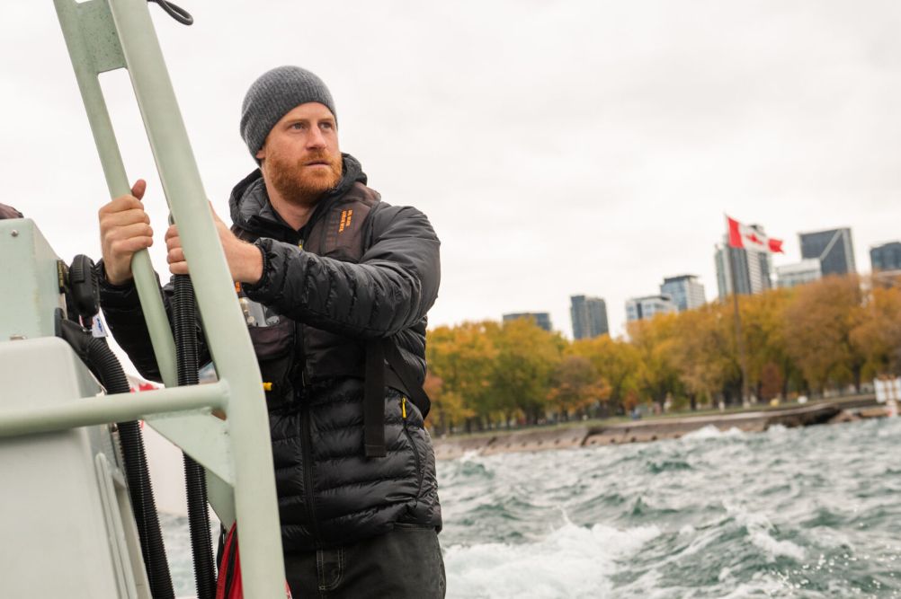 prince Harry on the side of a boat