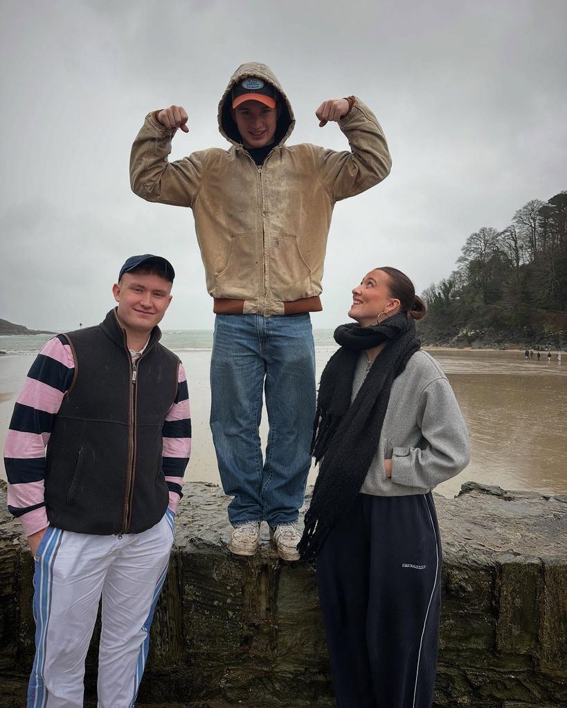 Three teenagers posing by the sea 