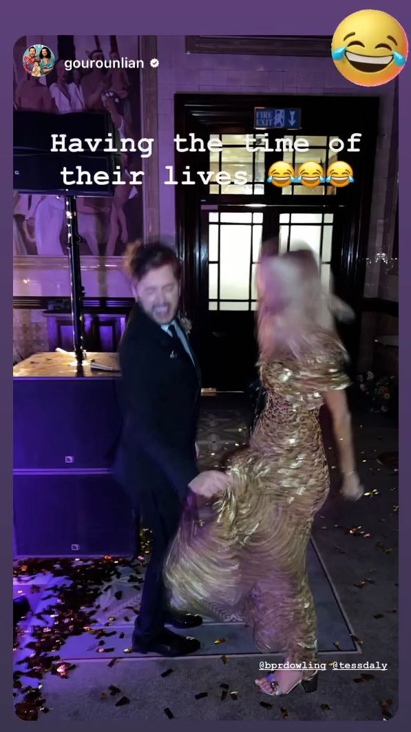 Tess Daly in a gold dress dancing with Brian Dowling